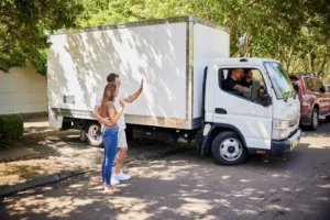 Couple standing beside a removal truck