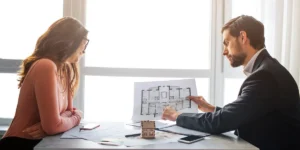 Couple reviewing a floor plan with an adviser
