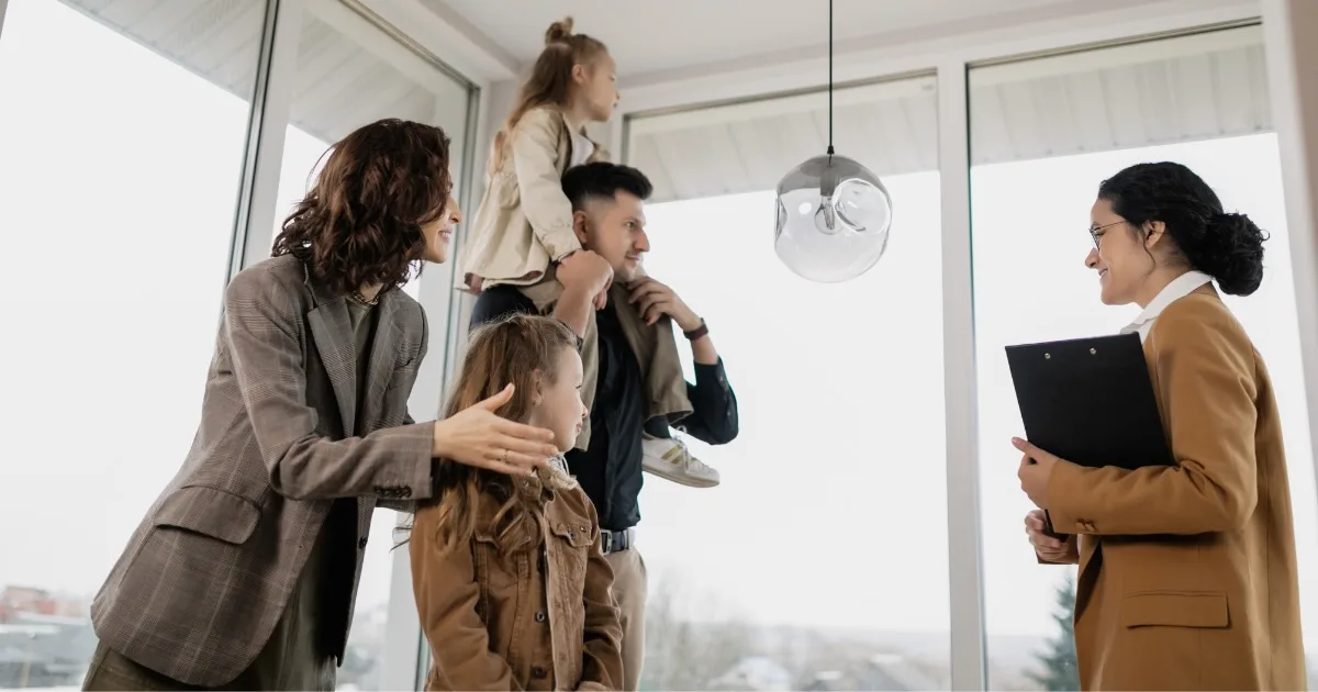 Family with two children speaking to an agent in a bright home