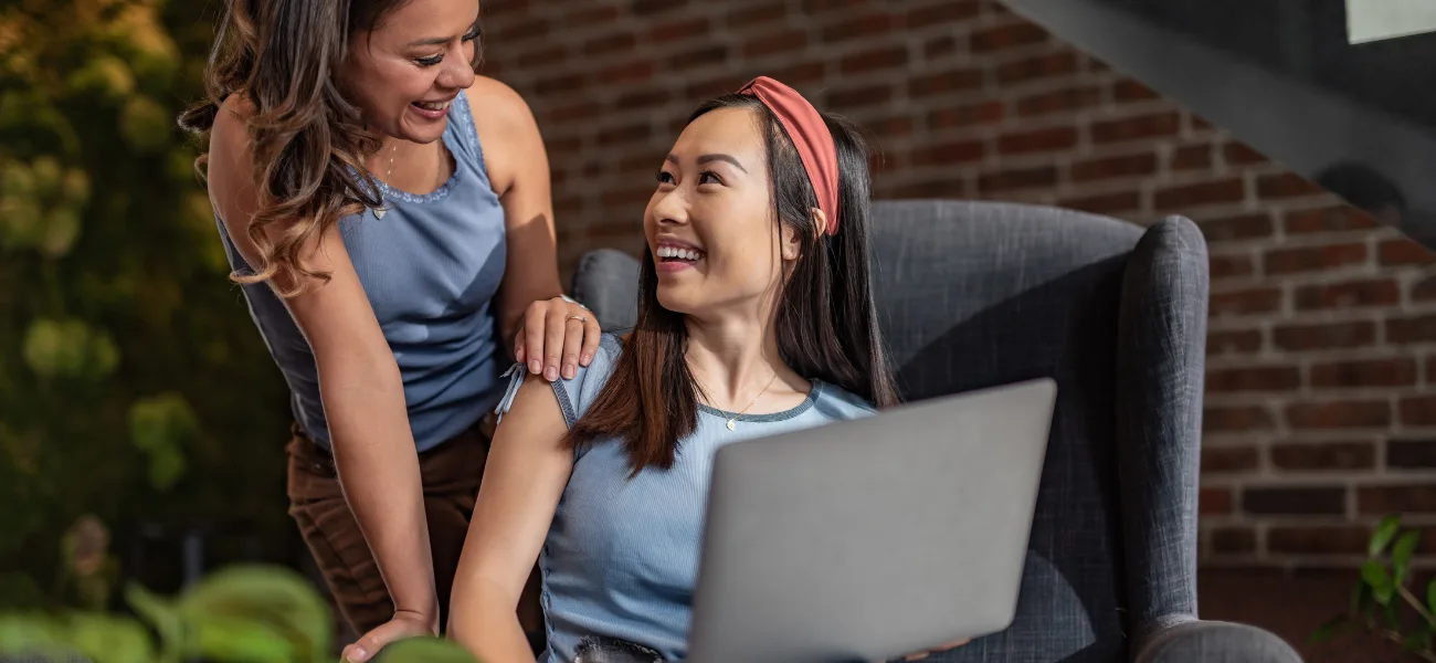Two women looking at a laptop together